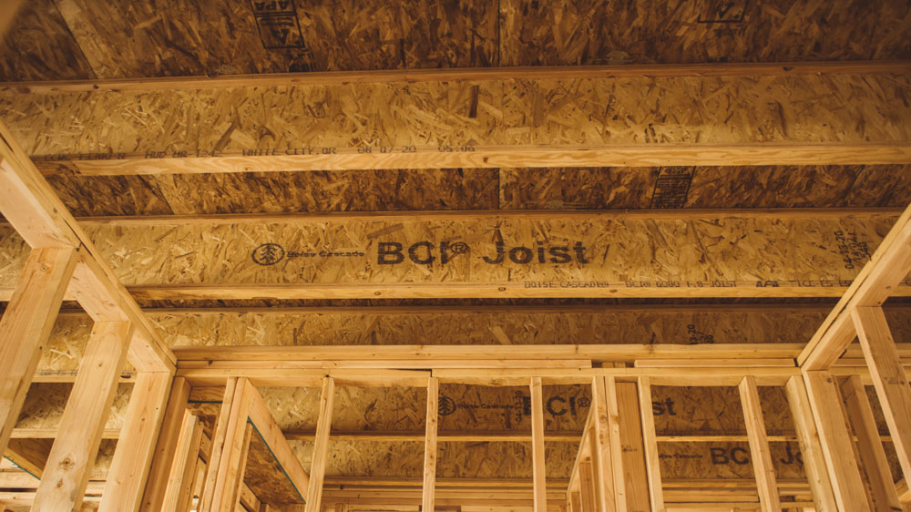 Boise Cascade BCI I-joists framing a floor and ceiling, stamped BCI Joist, showing the same flange-and-web cross section